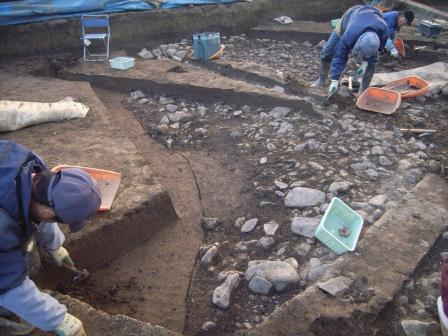 横田遺跡で発掘された洪水による地面の流失と堆積の写真